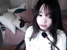 Korean chick masturbates above webcam